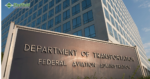 A large, bronze sign that reads “Department of Transportation Federal Aviation Administration” is in front of a tall, grayish building with many windows. This helps us understand that the blog is related, and it’s called FAA Dispatcher Schools.