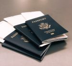 3 passports with plane tickets sticking out